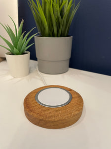Solid oak round, chunky smooth with circular excess for push fit to hold MagSafe charger. Wire slots on the underside and micro suction feet to stick to smooth solid surface. Smooth tactile finish 90mm diameter.